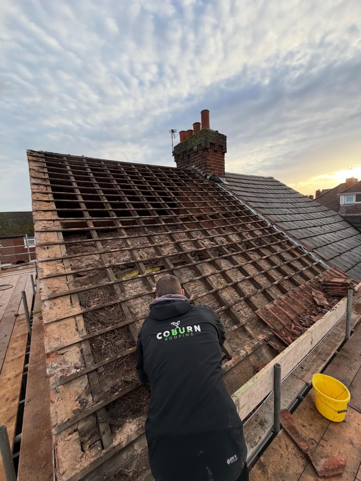 Coburn Roofing team stripping a roof for re-roofing